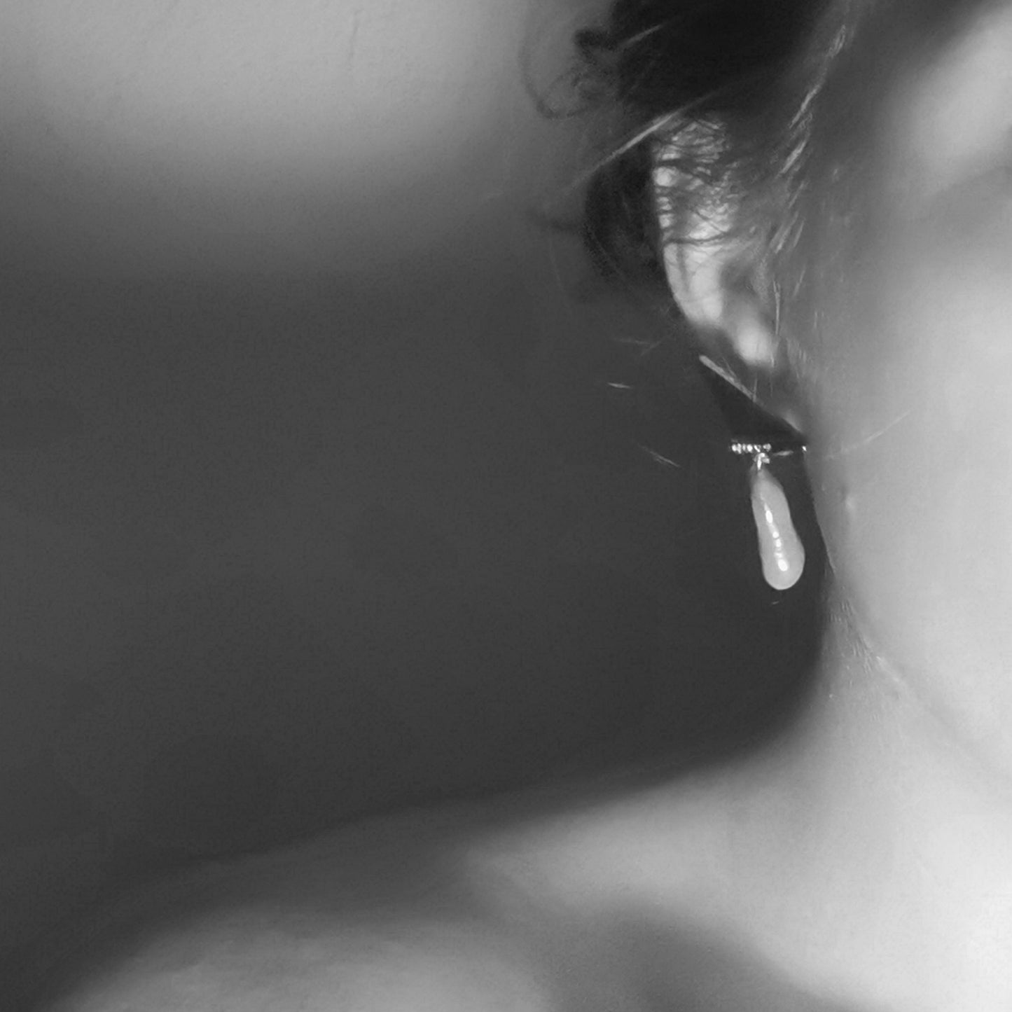 Baroque Pearl triangle earring worn on