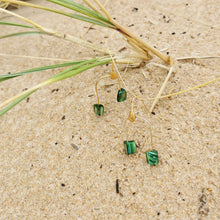 Load image into Gallery viewer, Green shell earrings photographed at the beach