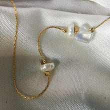 Load image into Gallery viewer, Close up fo pearls and opal necklace on gold olates snake chain