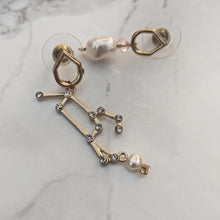 Load image into Gallery viewer, Mismatch Earrings with stellar sign freshwater pearls and swarowski crystals marble background