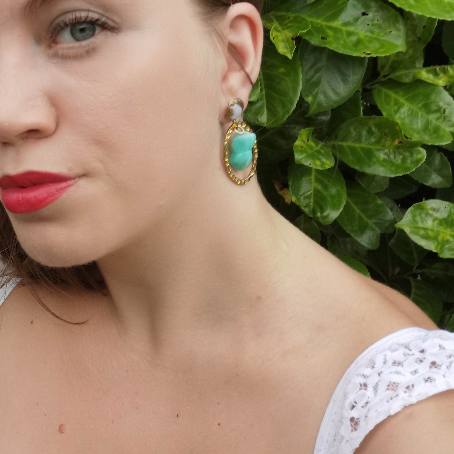 Mint Mucha earrings worn on
