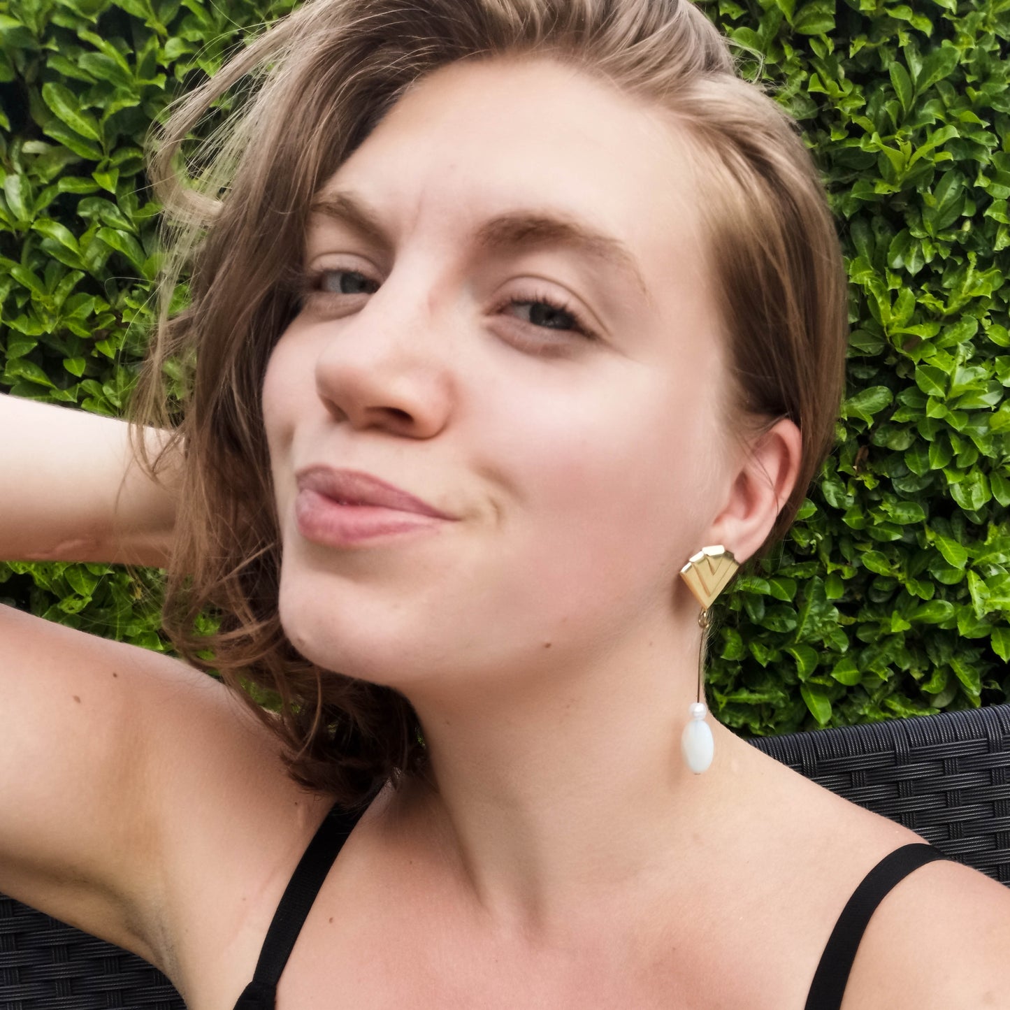 Fan studdded earring with opal and boehem pearl drop on pin worn on