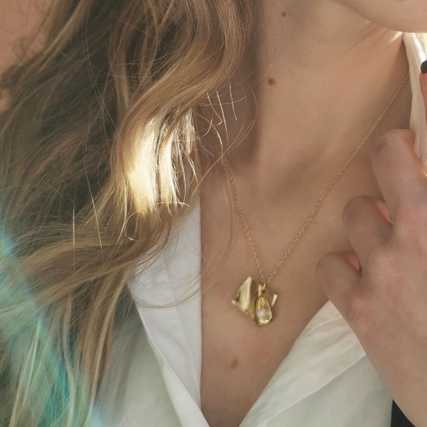 Open book necklace worn on