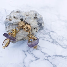 Load image into Gallery viewer, Geometrical earrings with triangle and oval shapes- gold coloured leaning on stone