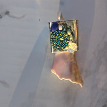 Load image into Gallery viewer, Silver coloured ring with blue, mint and opal details as worn on shell