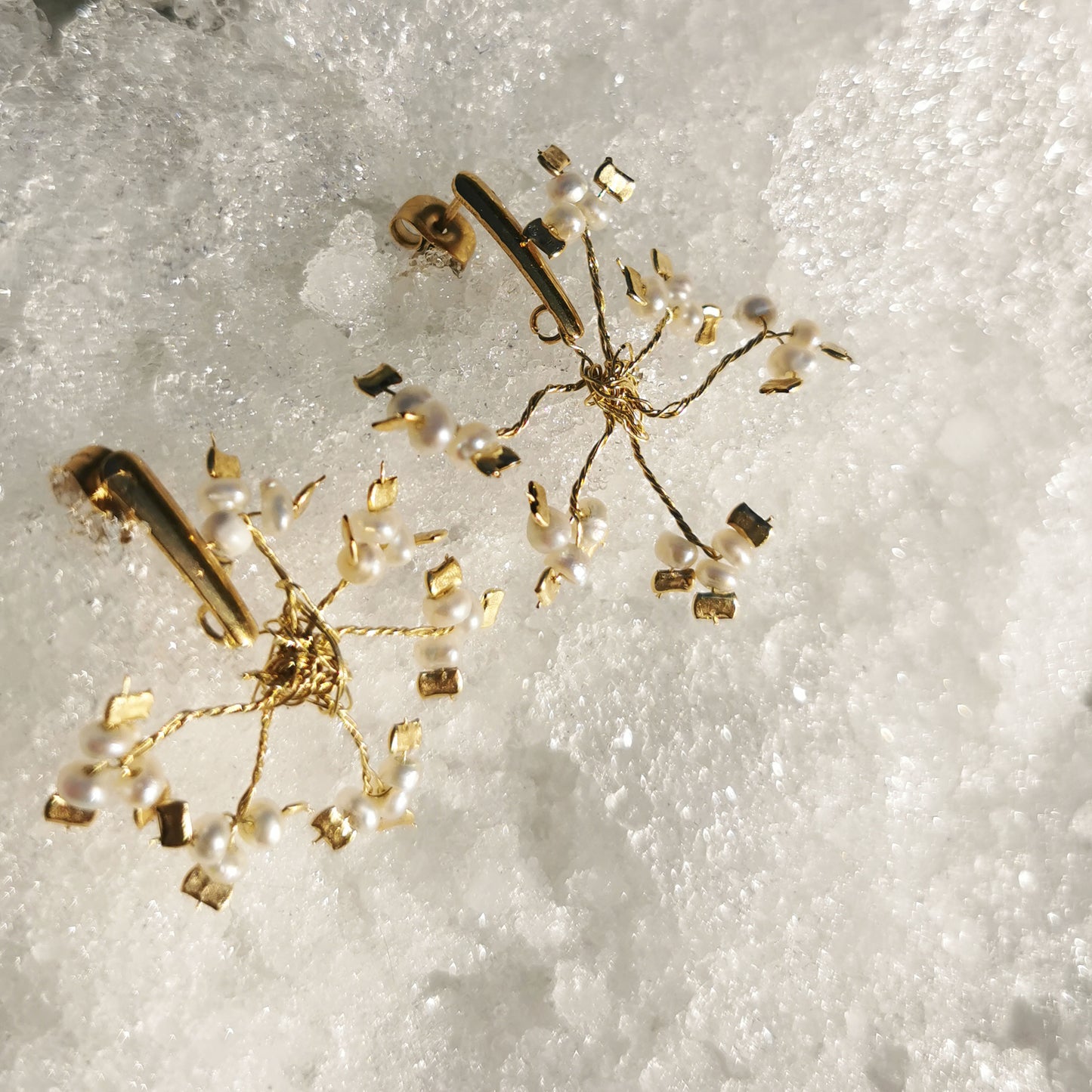Snowflake earrings inside snow
