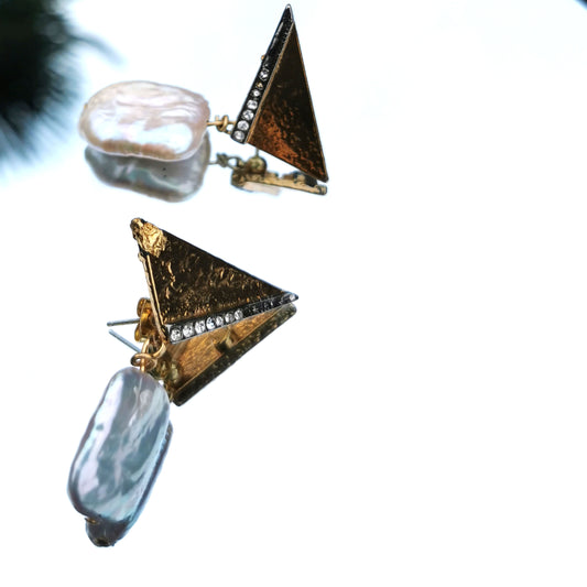 Baroque pearl drop earring with retro stud photographed on mirror