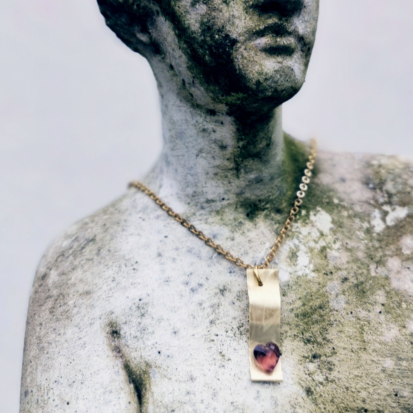 Brass charm necklace on Venus statue