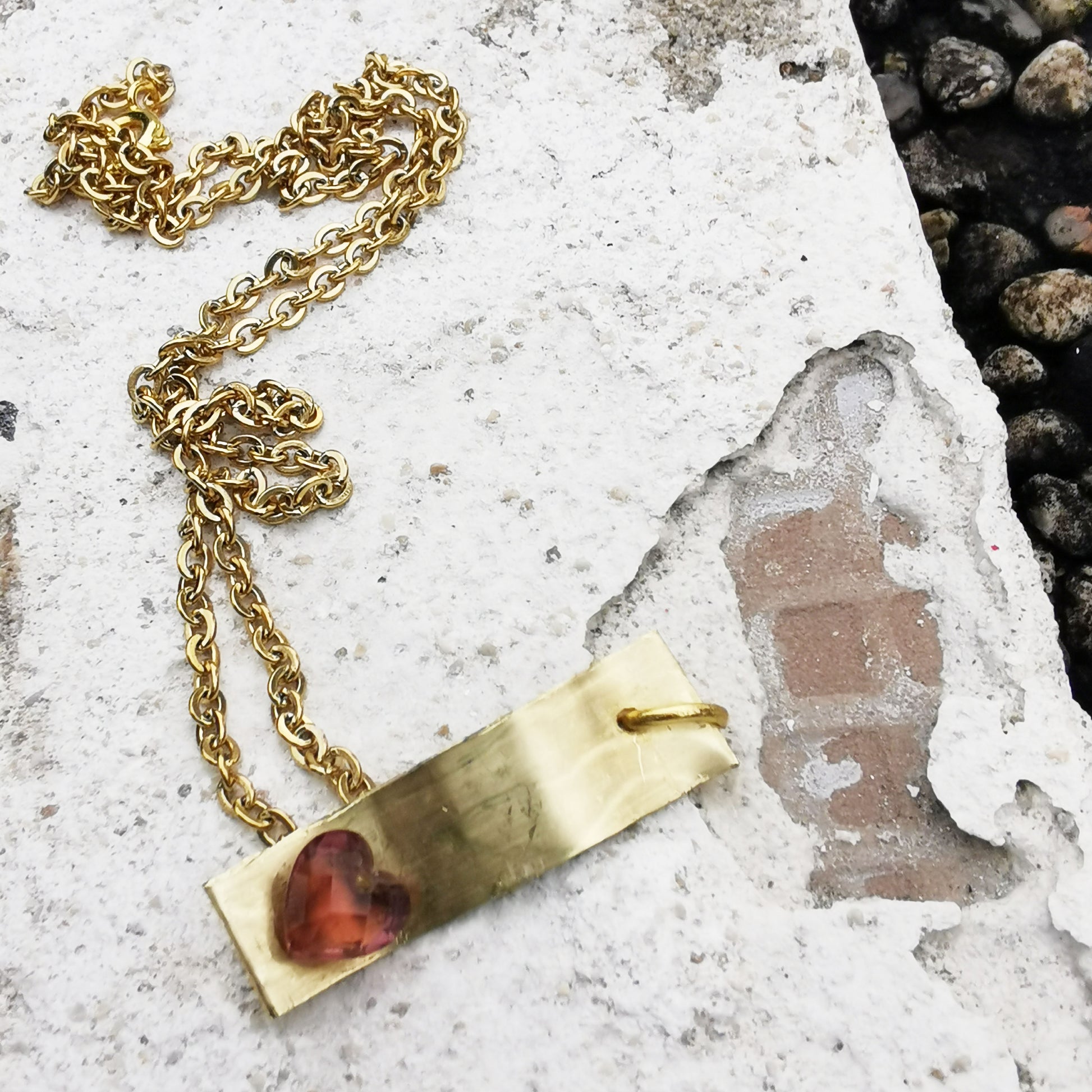 Brass Charm necklace on Marble 