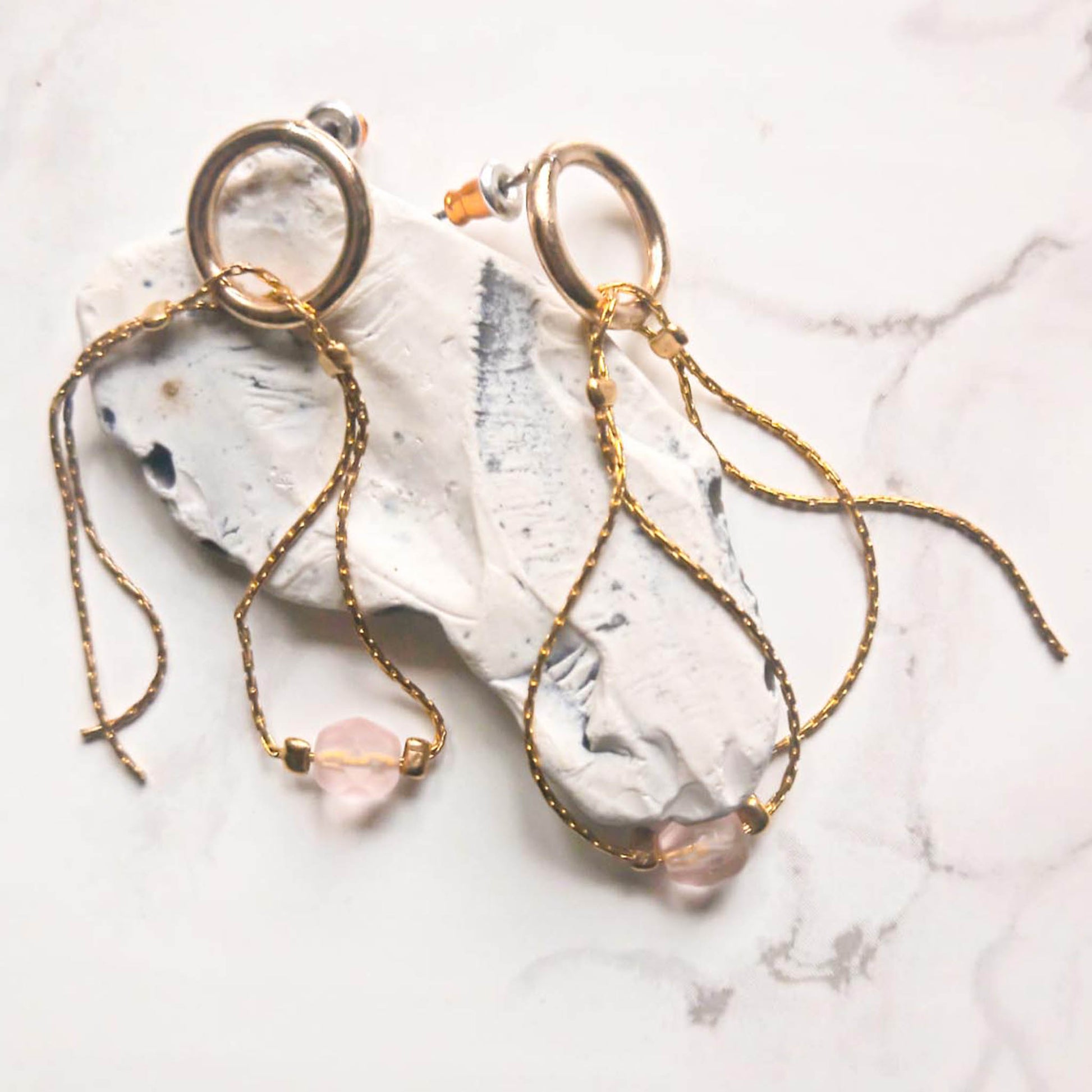 Stud earrings with pendant chains and pink beads