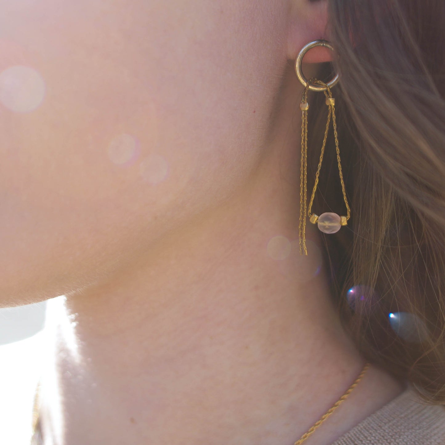 Stud earrings with pendant chains and pink beads