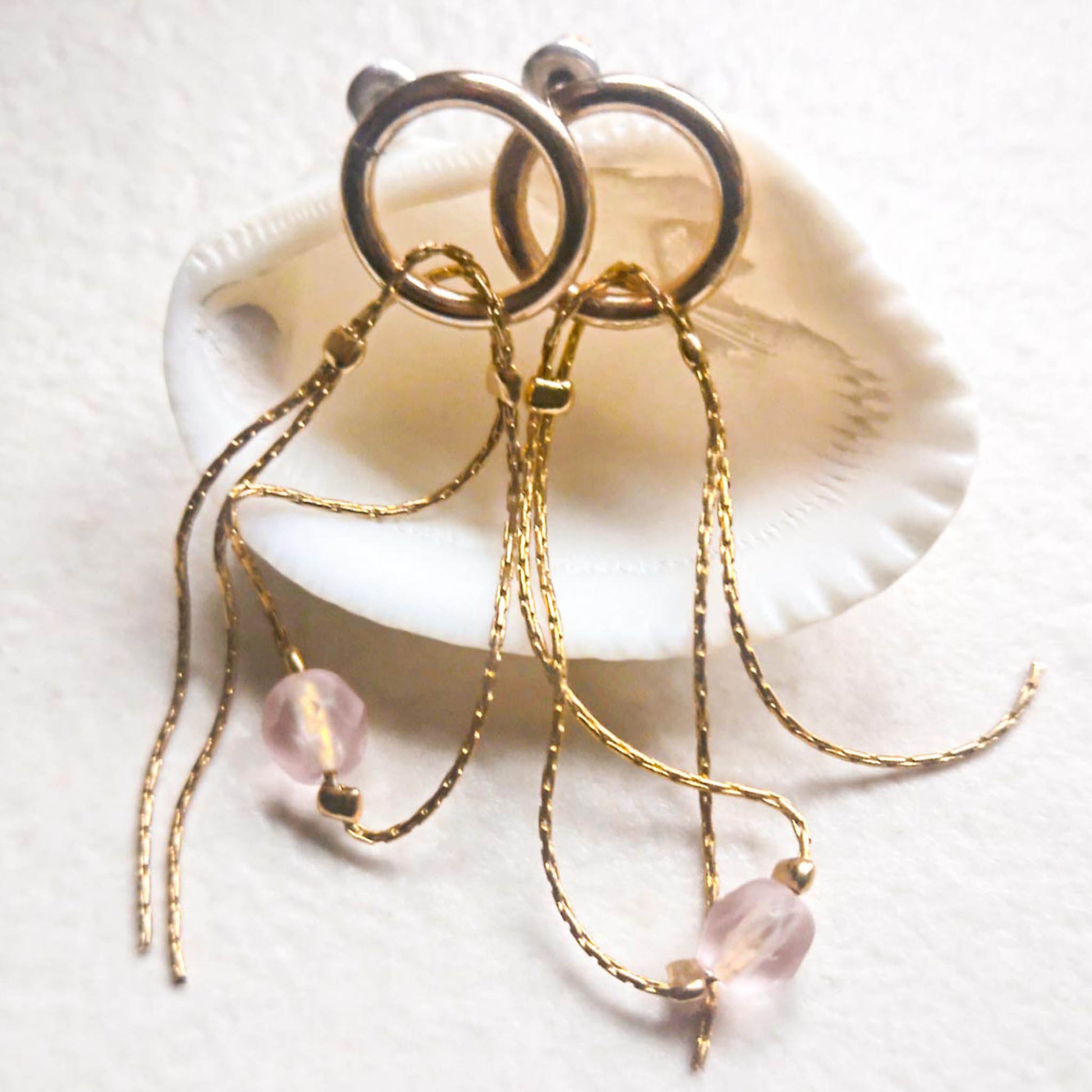 Stud earrings with pendant chains and pink beads