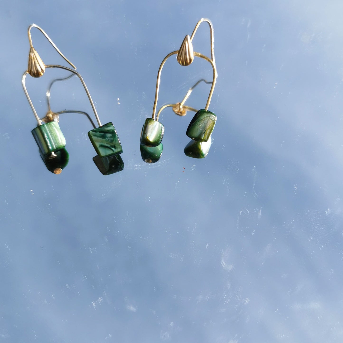 Green shell earrings reflection