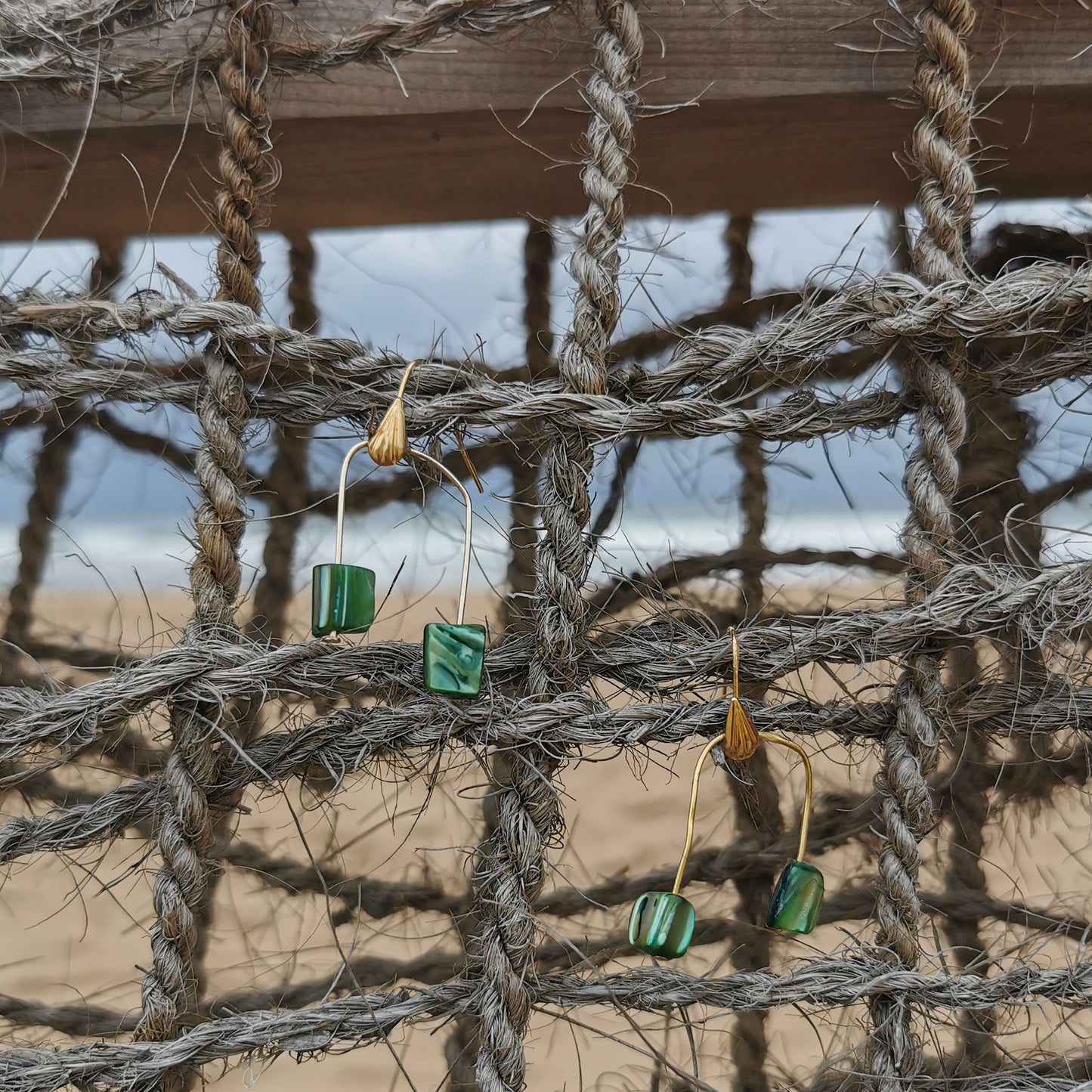 Green shell earrings at the beach net