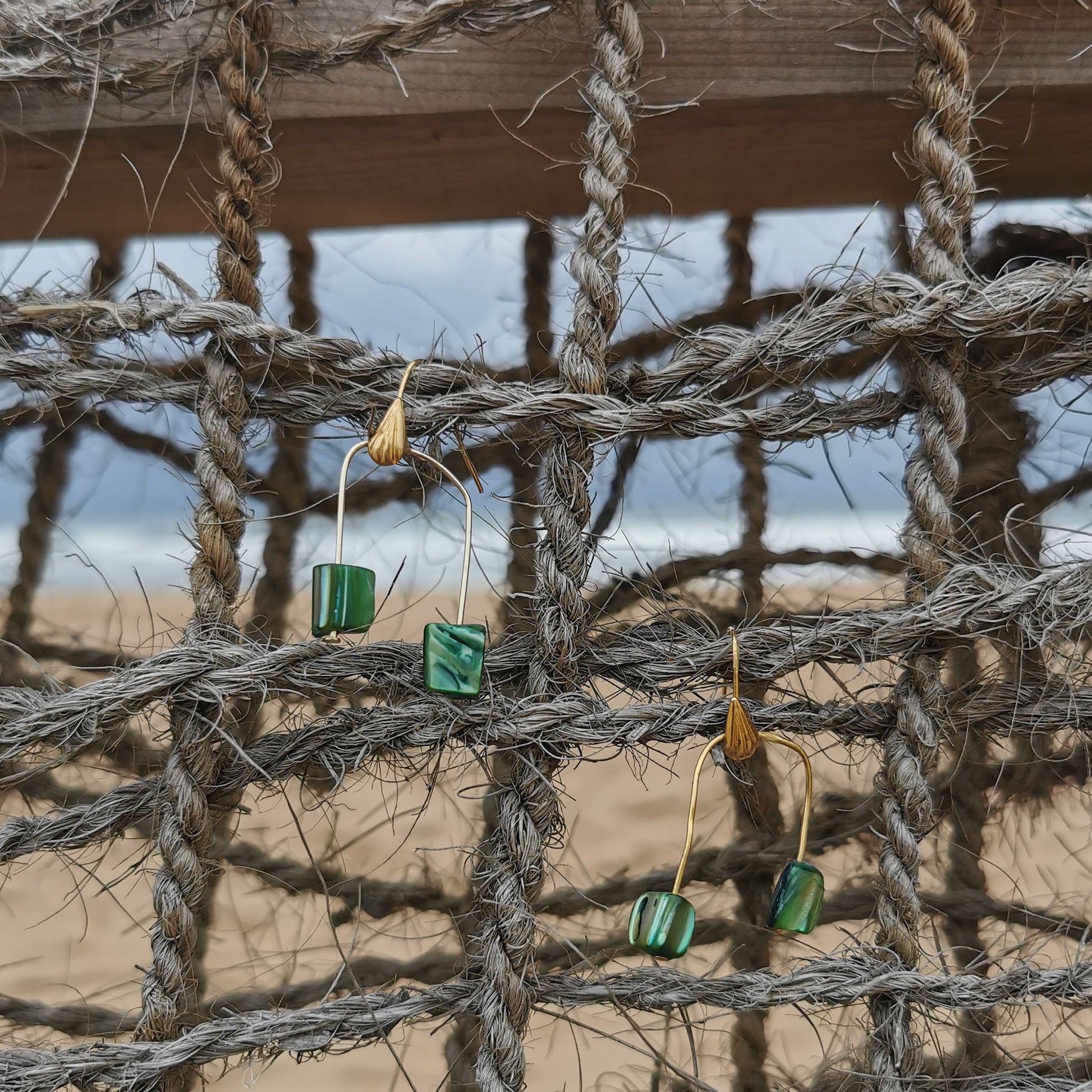 Green shell earrings at the beach net