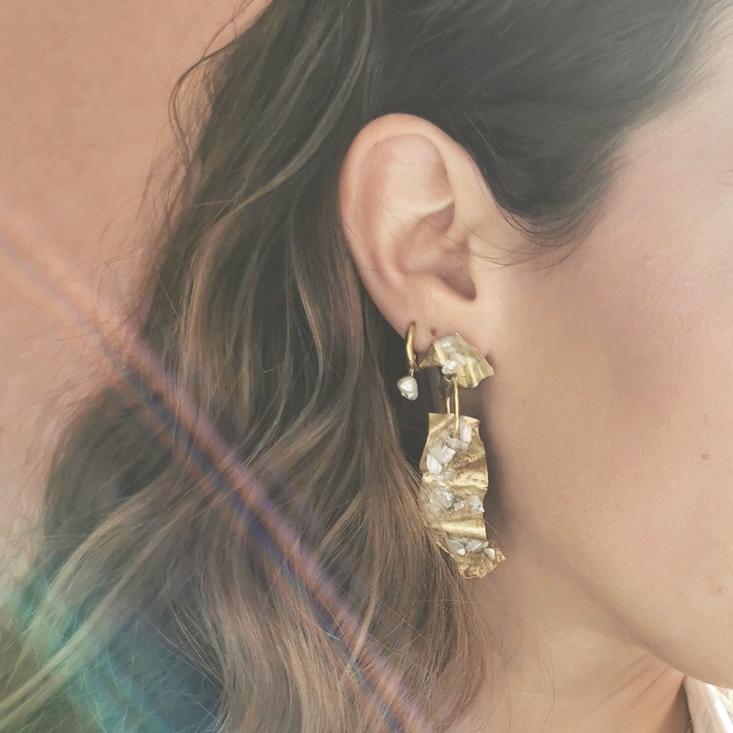 Cloud earring worn on