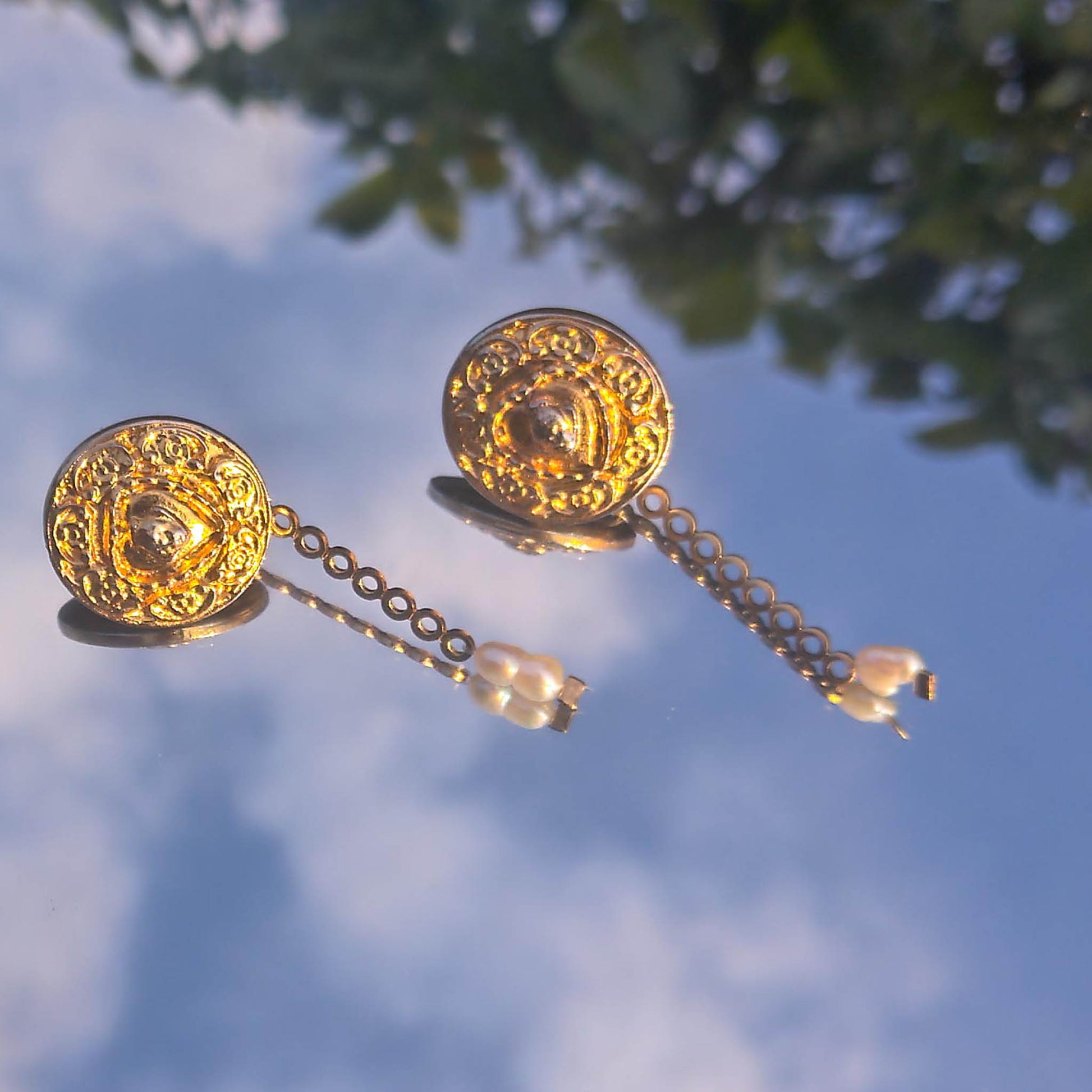 Donatella earrings- textured stud earrings with dainty freshwater pearl detail reflected