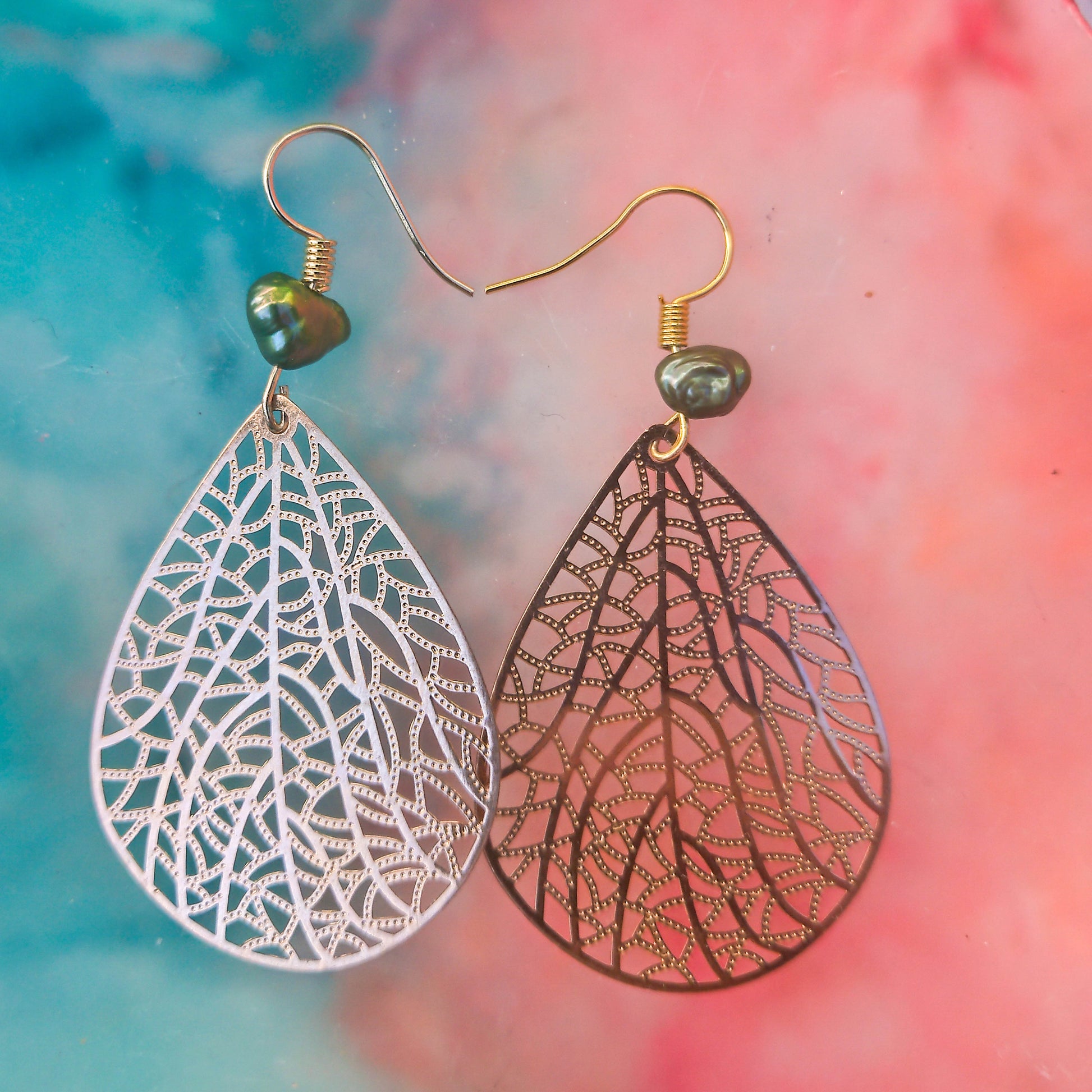 Thin earrings with green pearls