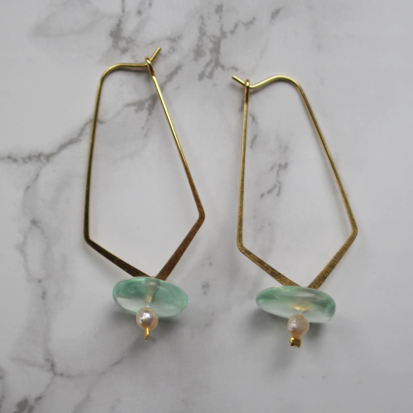 Goldie earrings marble background 