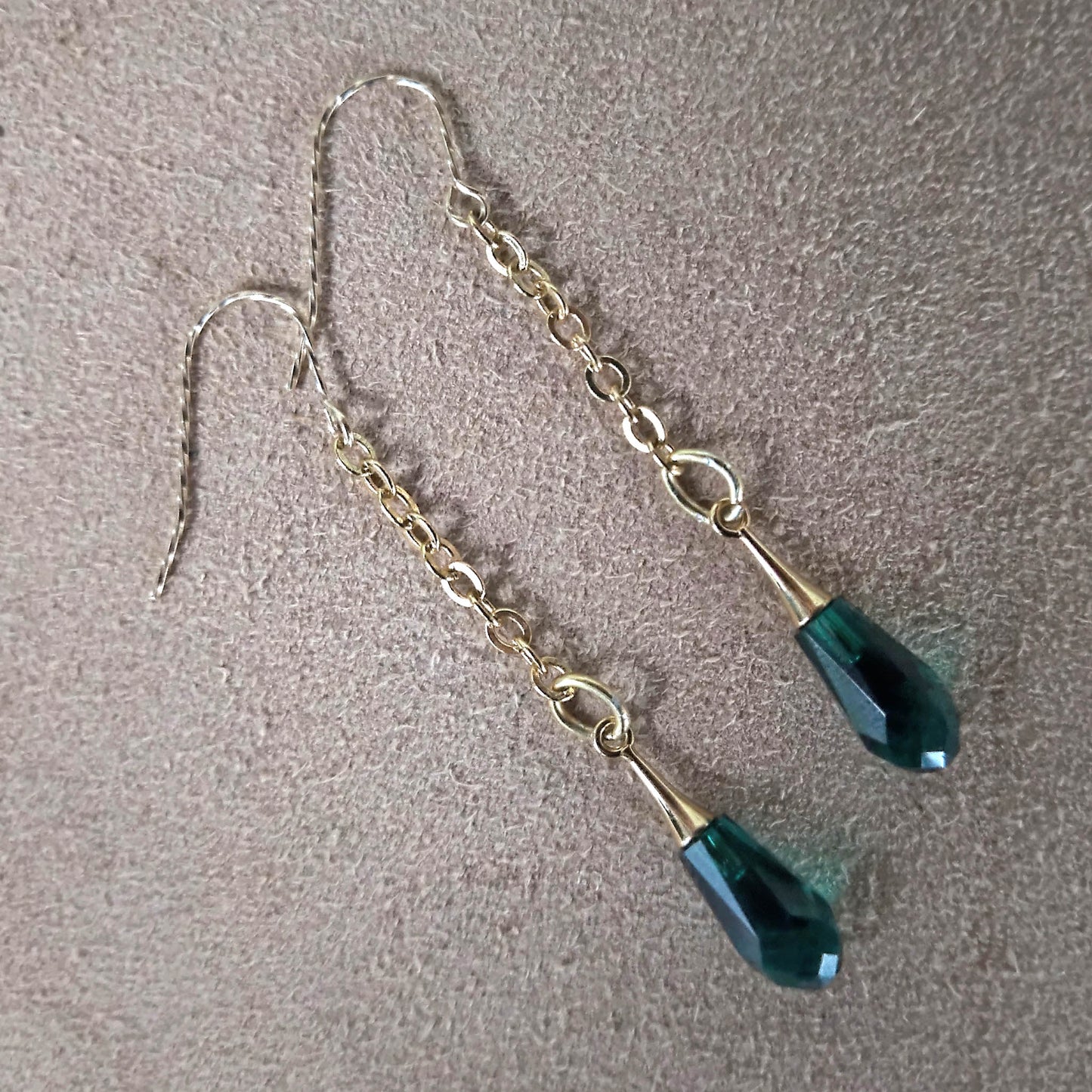 Green swarowski crystals hanging from cable chain earrings. Gold plated twisted hooks 