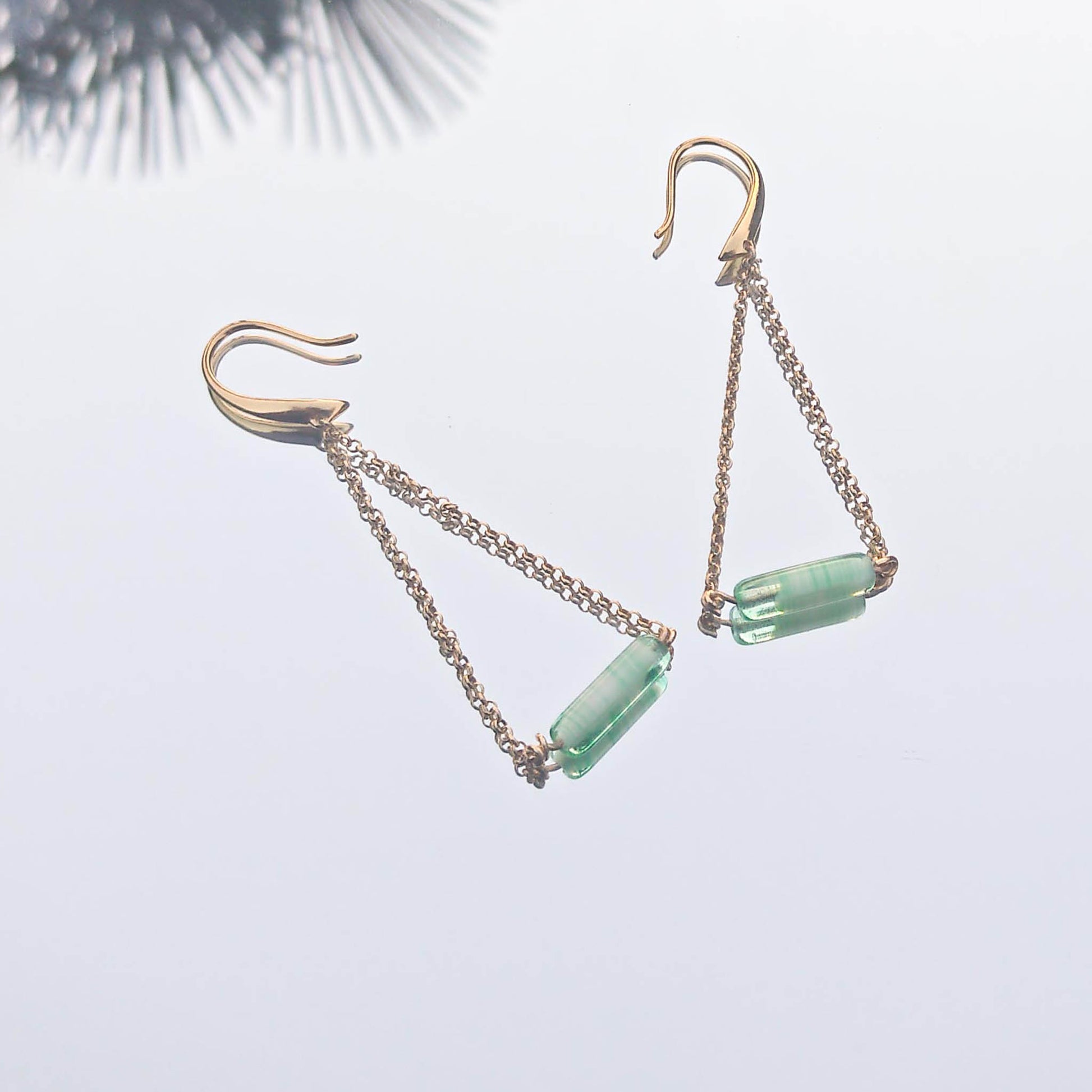 Je T'Amie Mint chain triangle earrings reflection