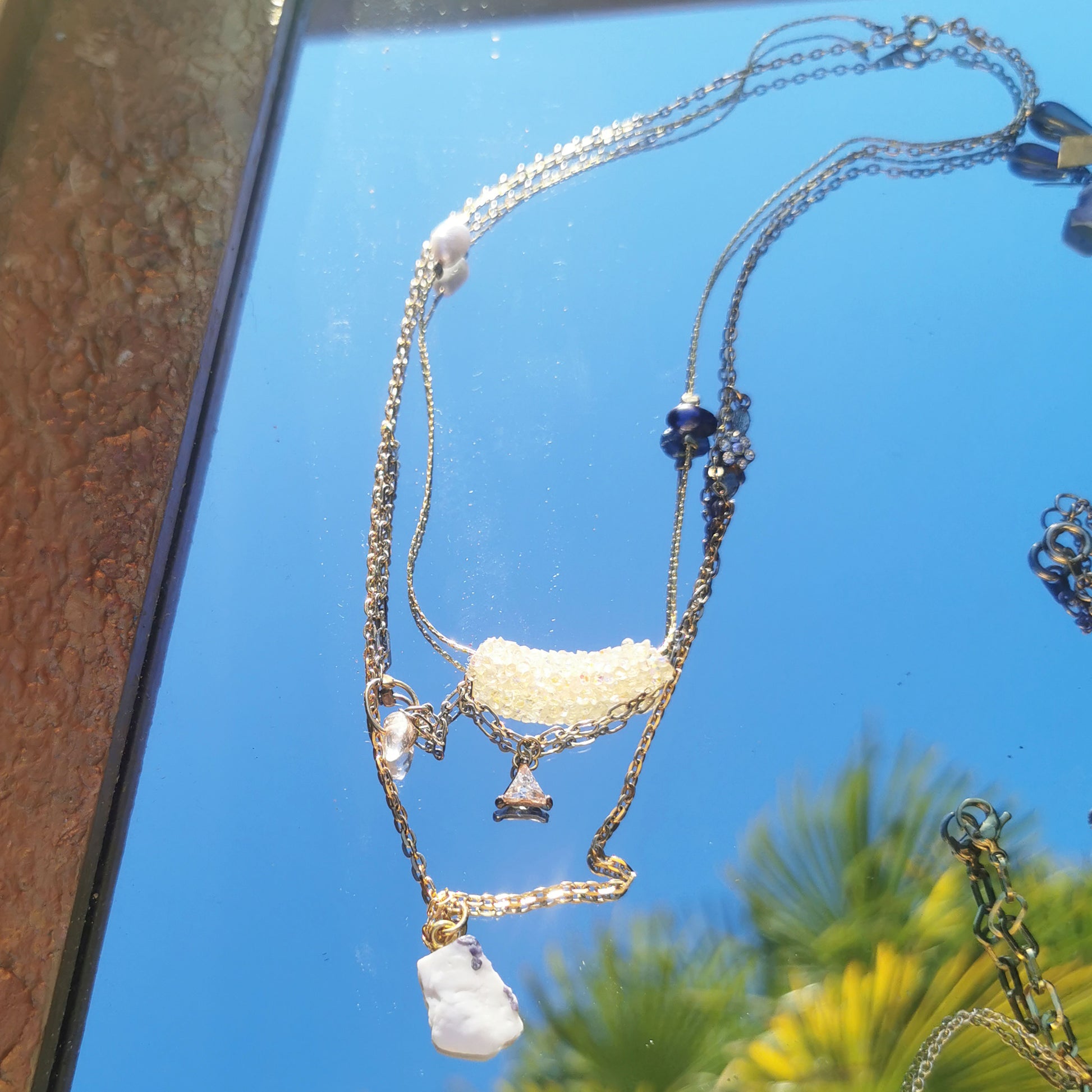 Aimee layered necklace reflected in mirror