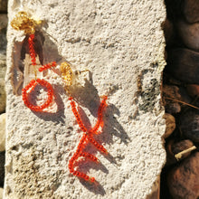 Load image into Gallery viewer, Love earrings photographed on marble
