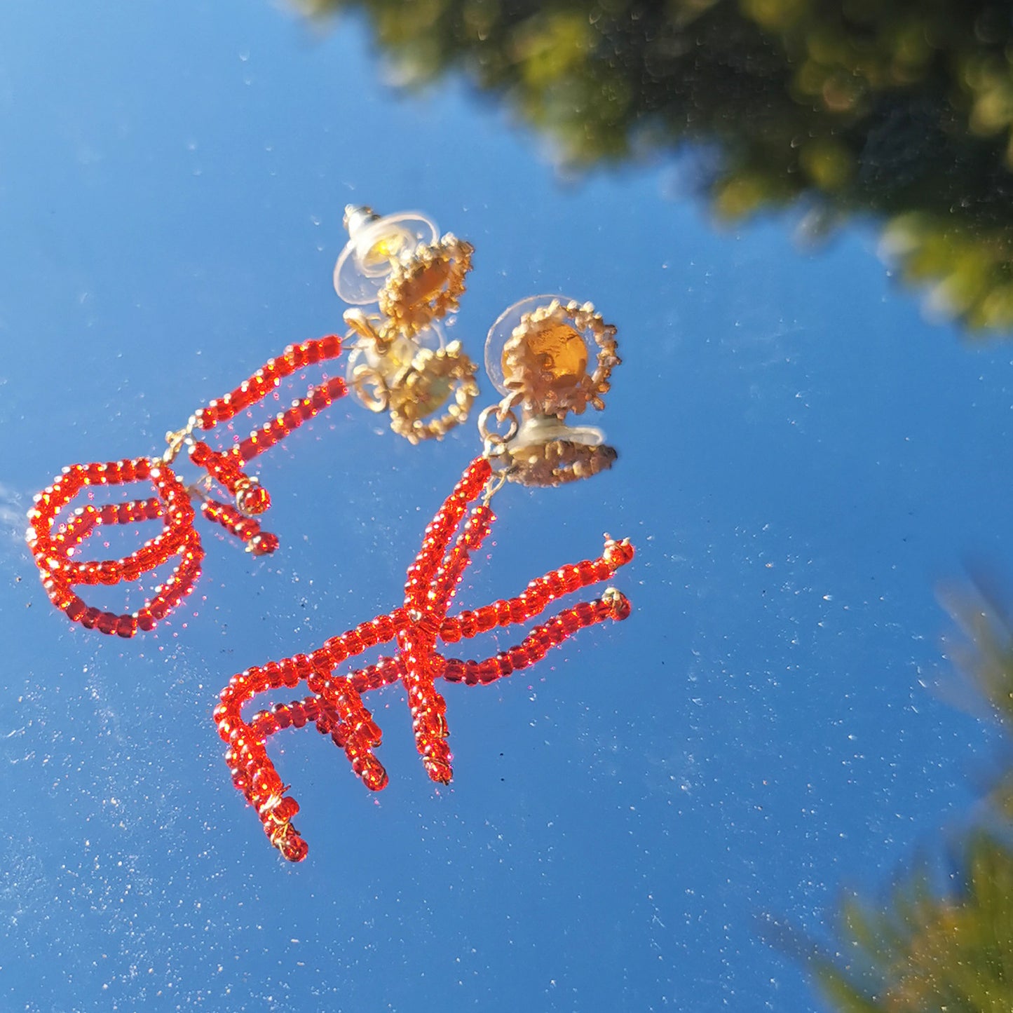 Love earrings photographed in mirror