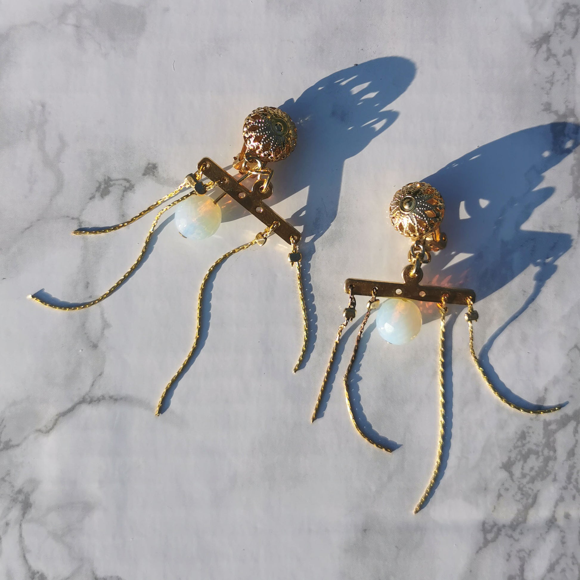 Opal Clip on earrings on marble background