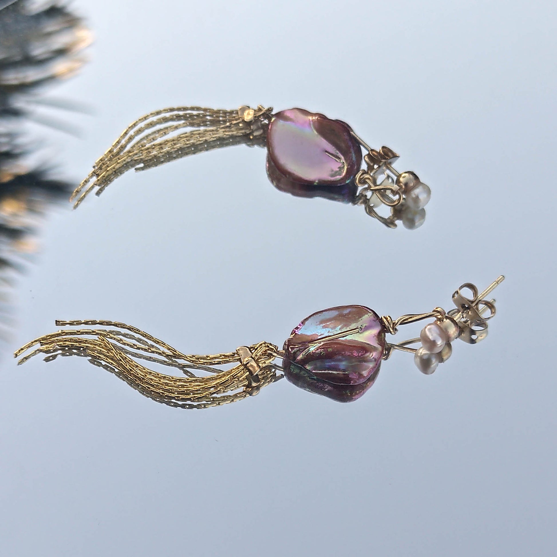 Orange keshi shells light interplay details. Tassle and freshwater pearls details 