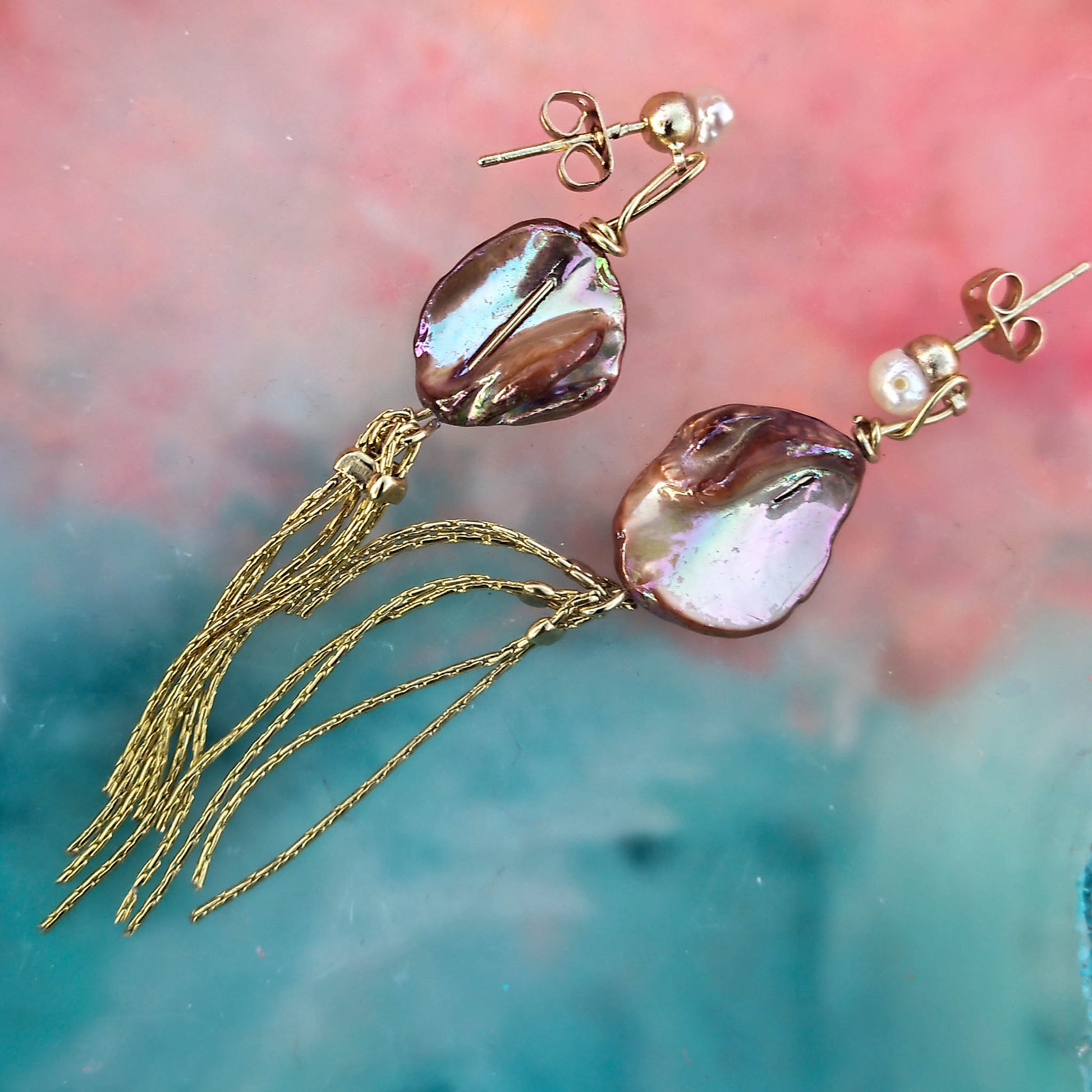 Keshi pearl earrings with tassle and freshwater pearl studs and camifolla background  
