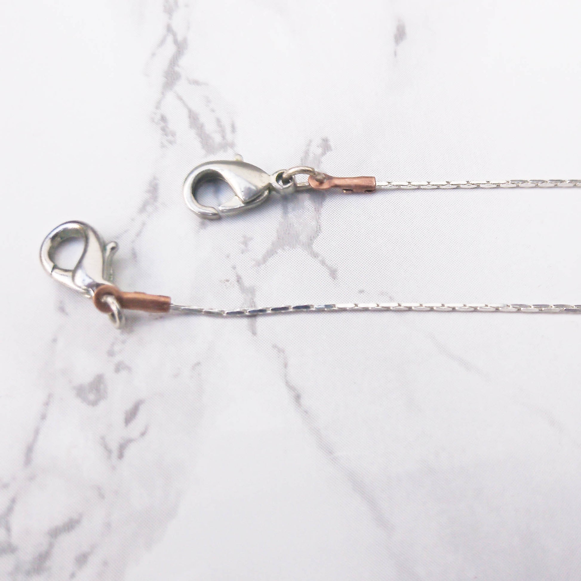 copper and silver closure