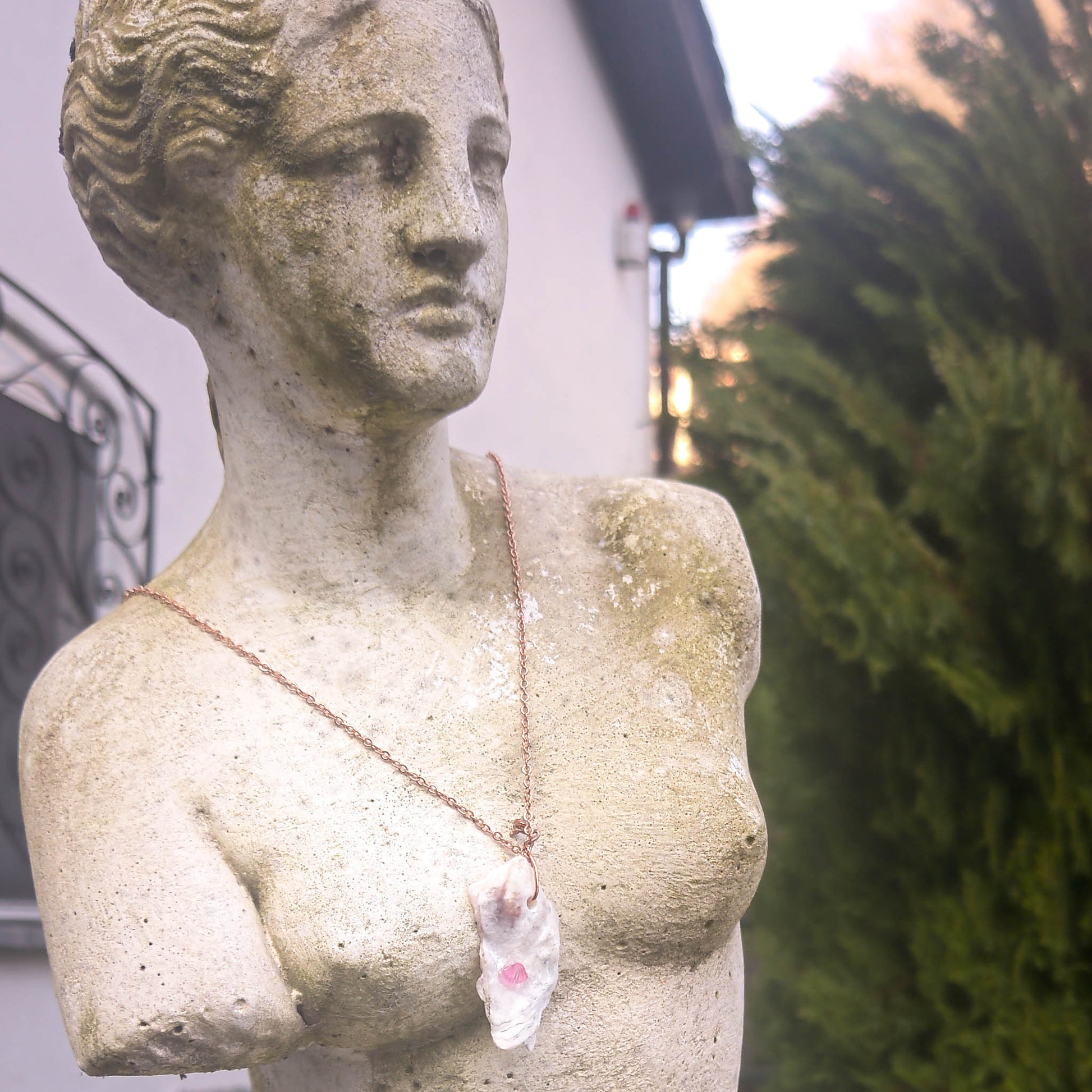 Rose gold plated necklace with shell pink swarowski crystal pendant worn by Venus 