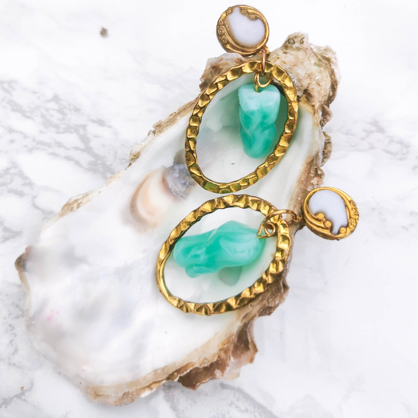 Textured stud, mint detail posed on shell