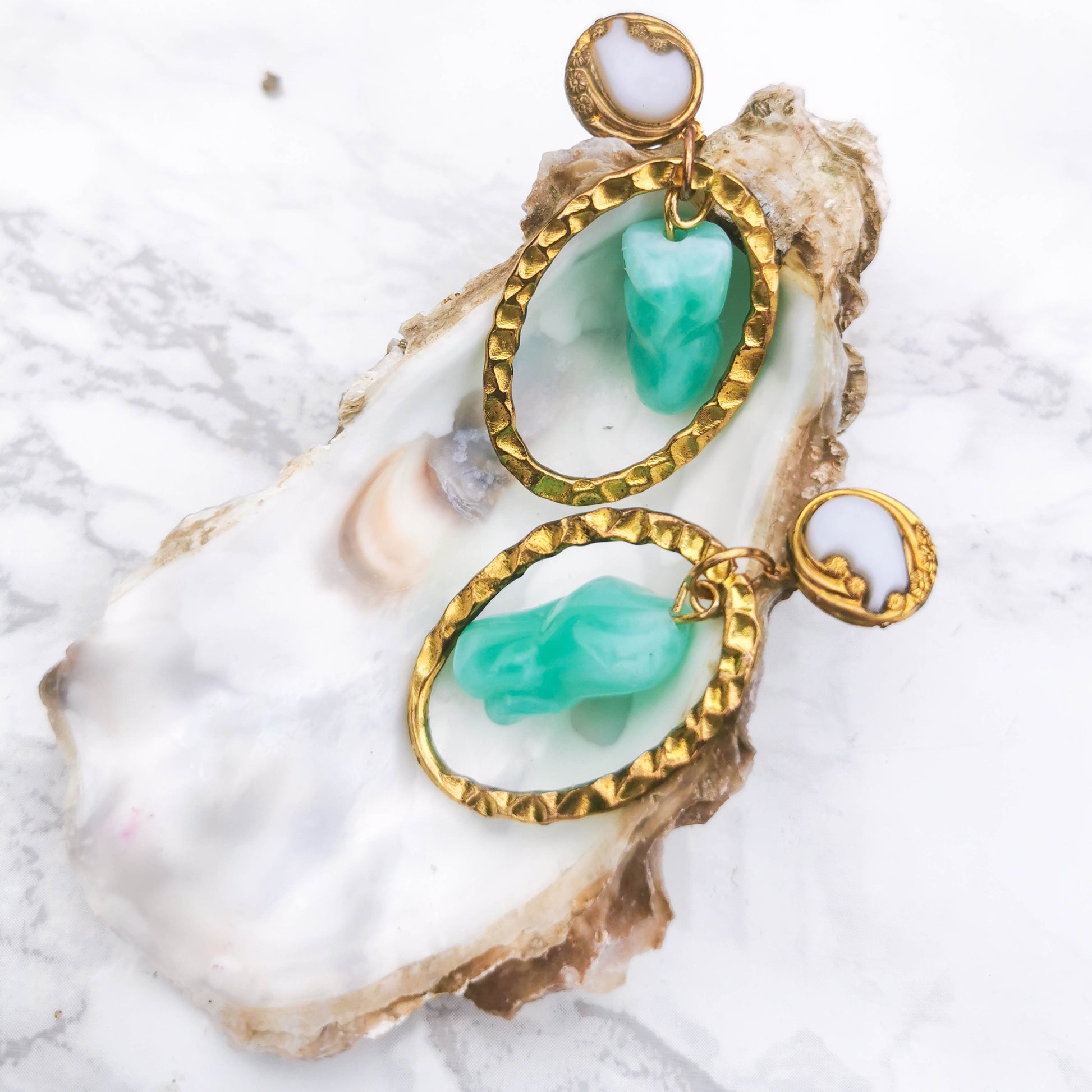 Textured stud, mint detail posed on shell