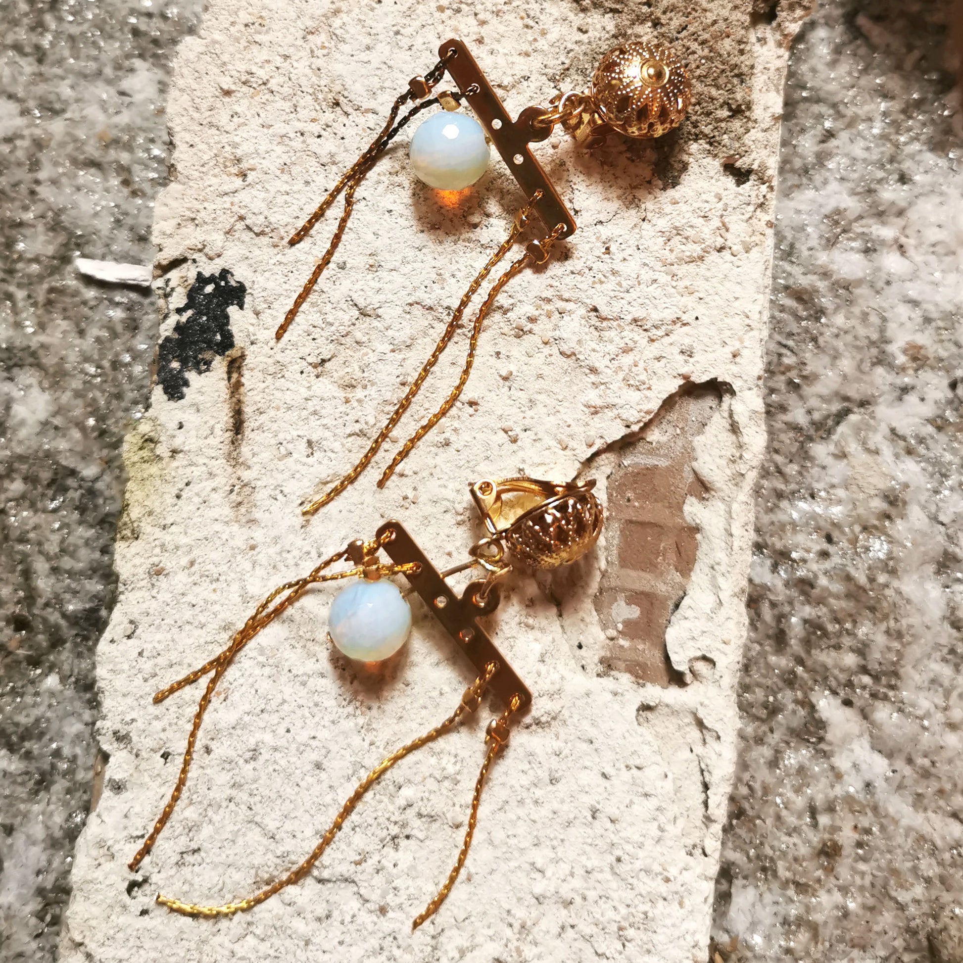 Opal Clip on earrings on gesso background