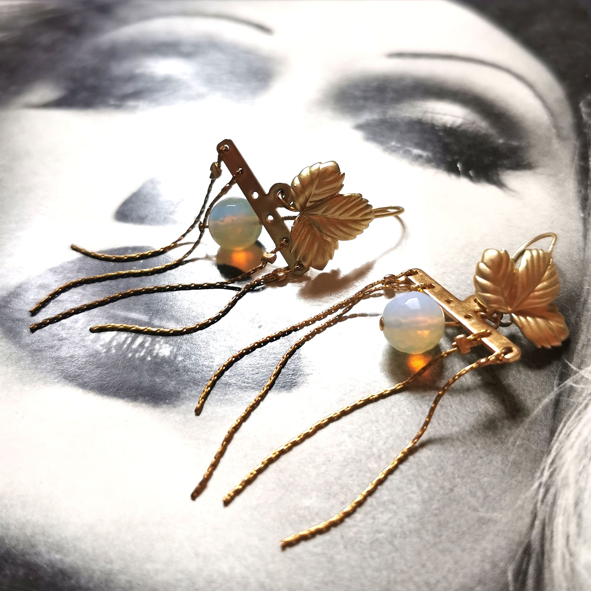 Opal leaf earrings on Vogue background