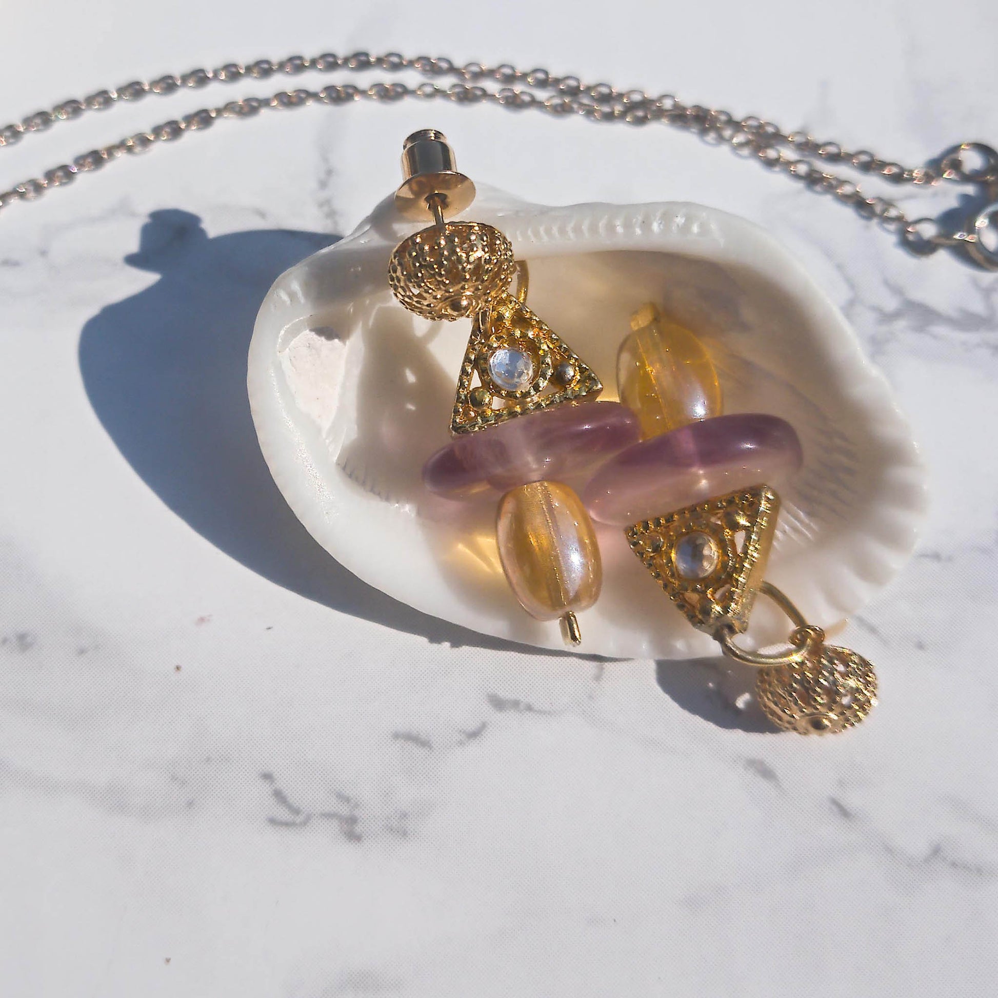 Pax earrings - geometrical earrings with rhinestone detail  leaning inside a shell