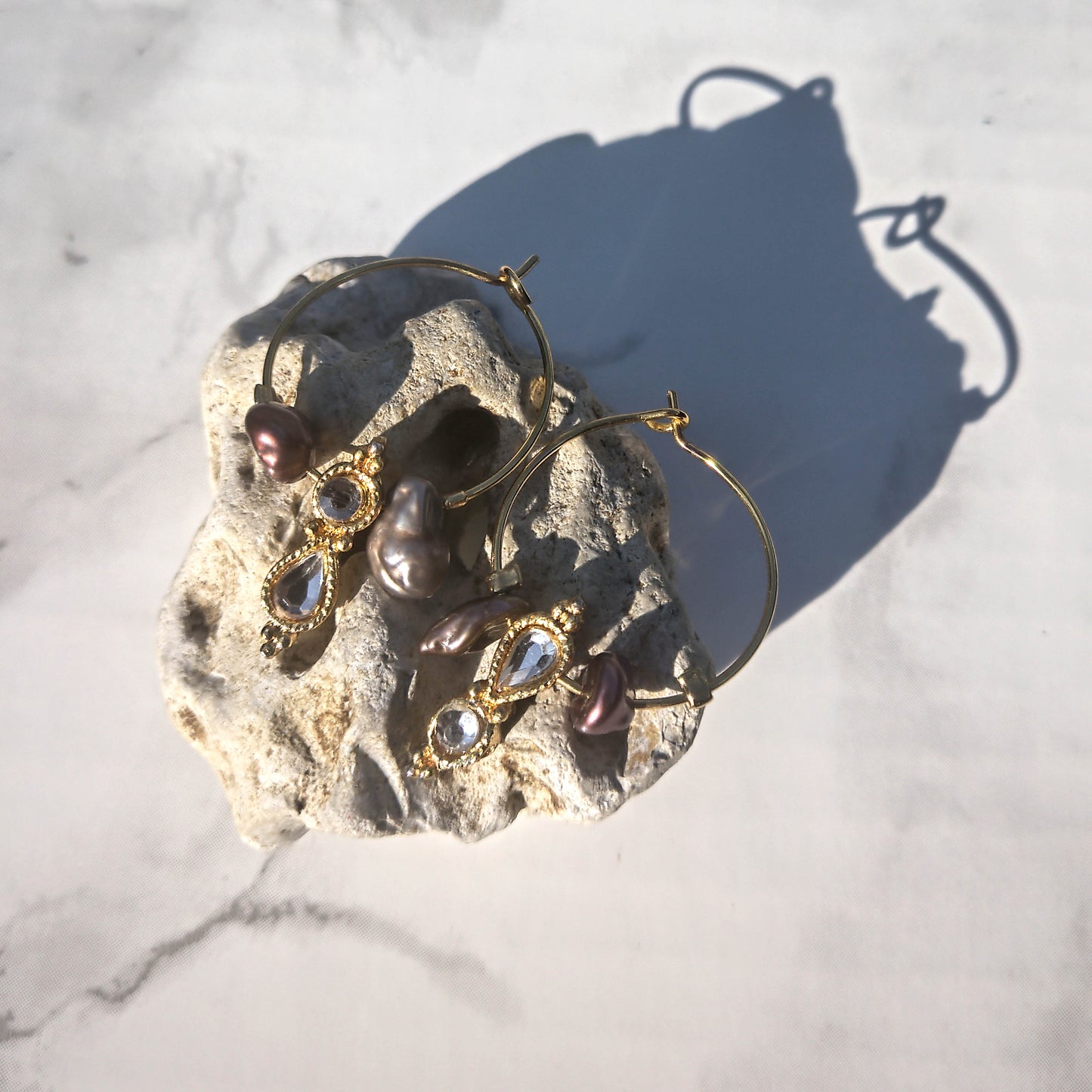 Peanut hoops and kishi pearls on stone