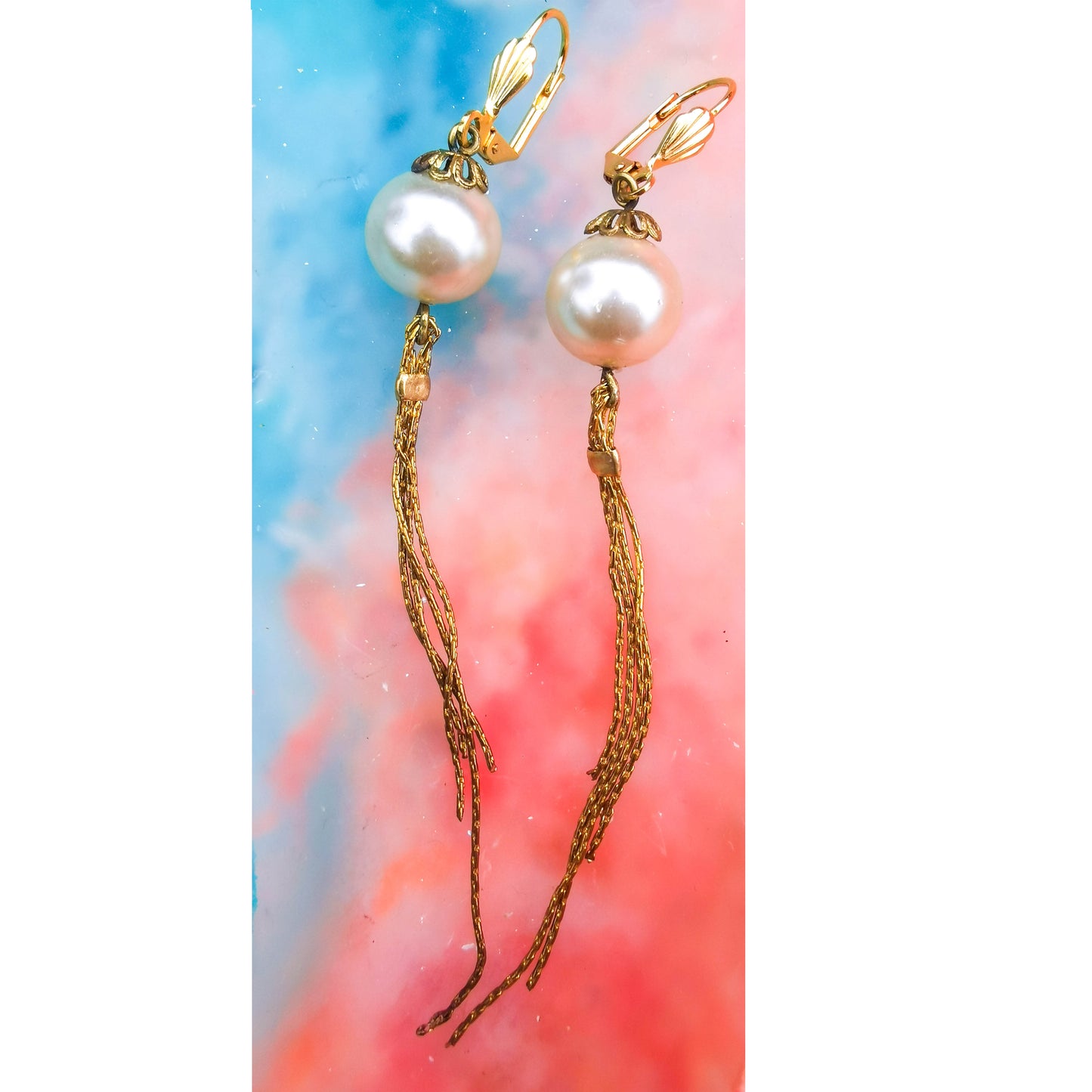 Pearl earrings with tassle on Camifolla background