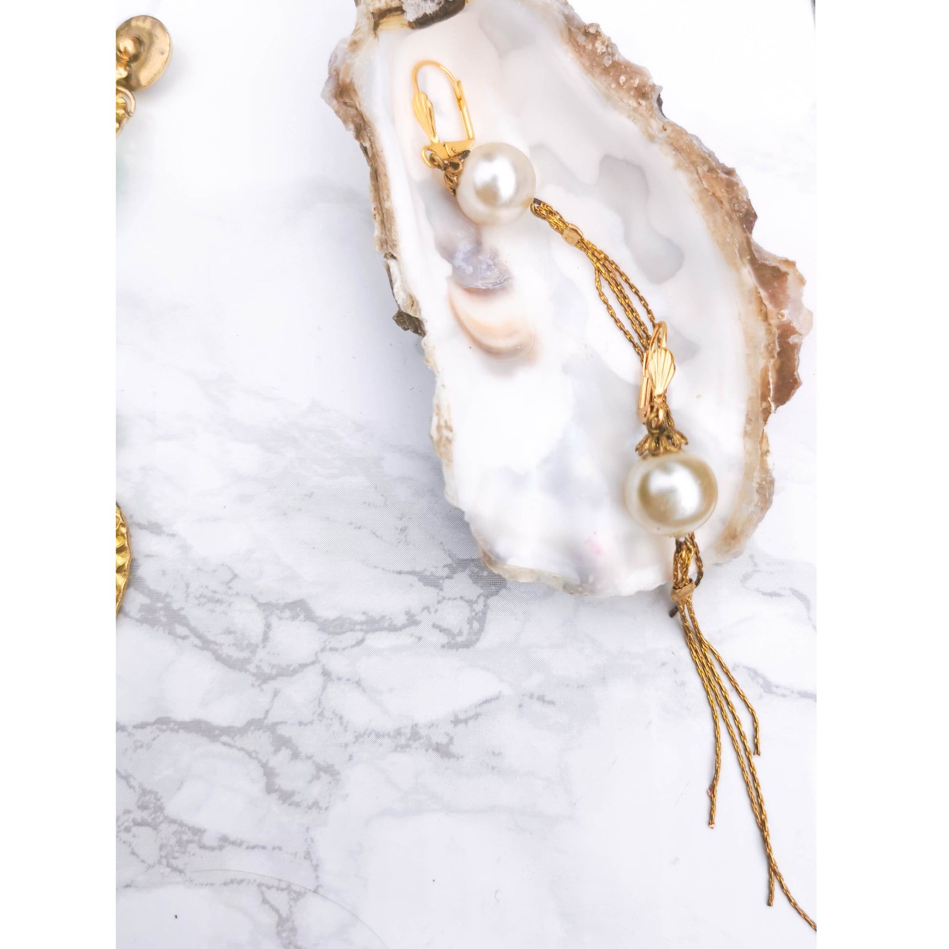 Tassle pearl earrings on oyster shell 
