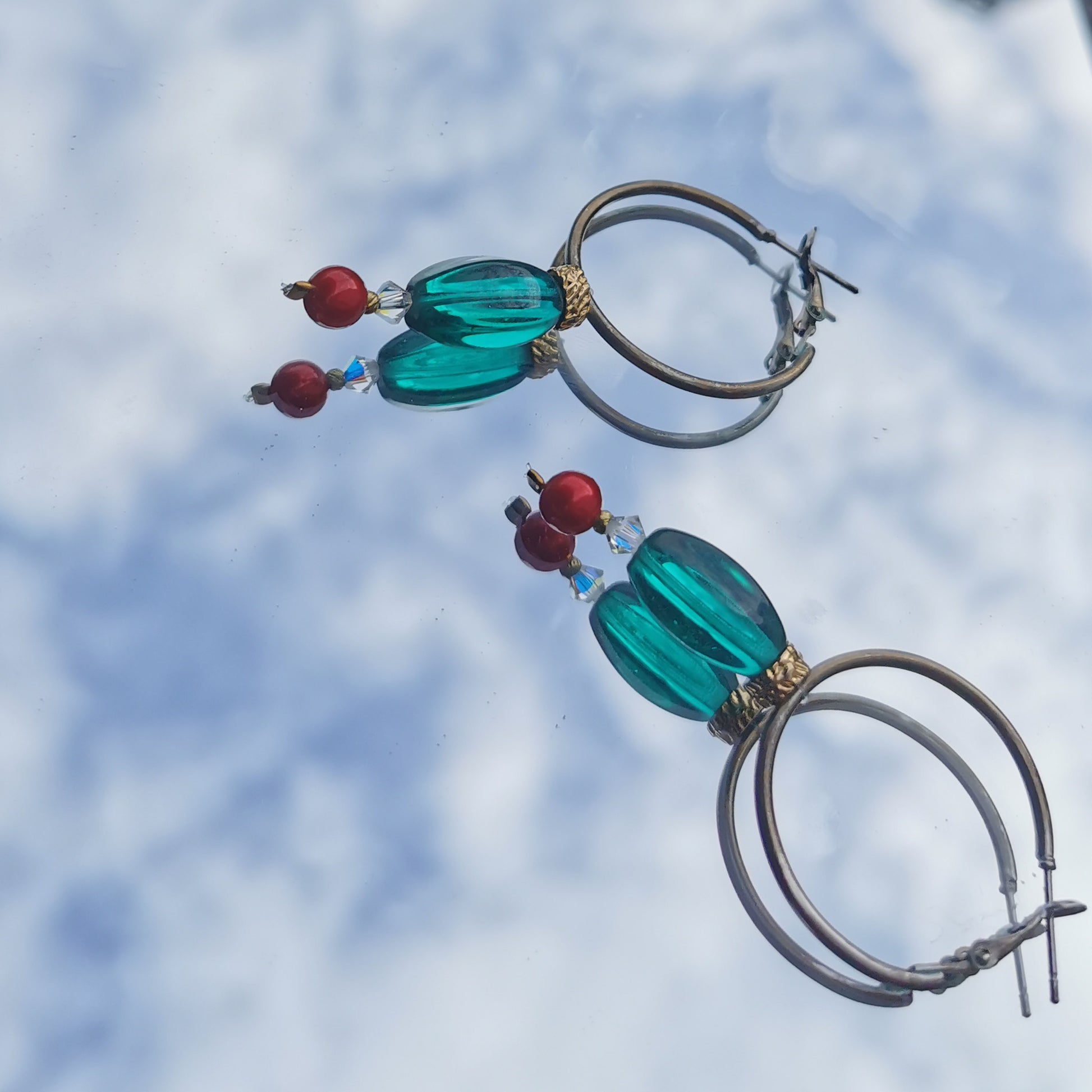 3cm hoops with green beads, gold detail, Swarowski crystal and boheme red pearl  photographed on mirror 
