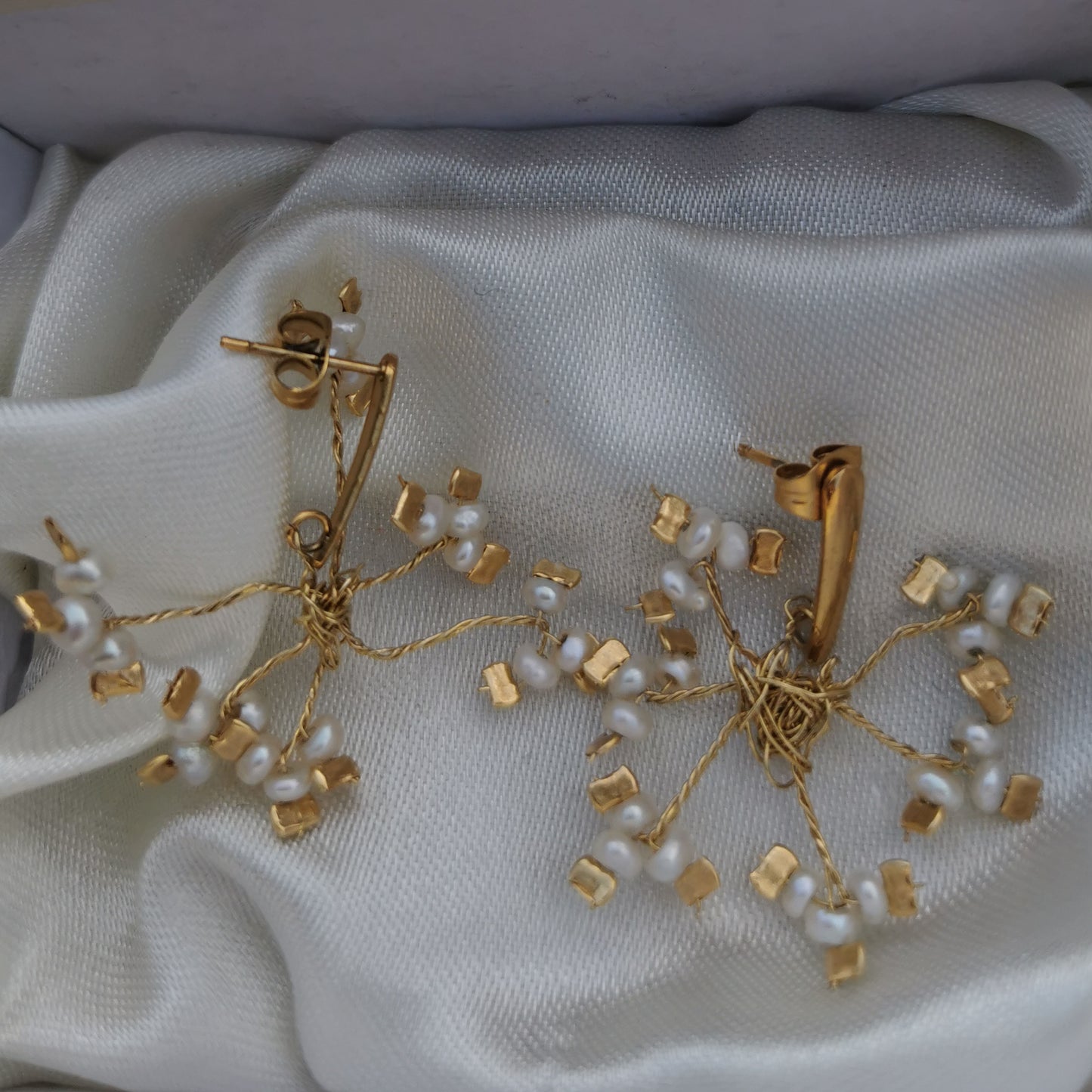 vintage pearls and brass handmade earrings on silk background