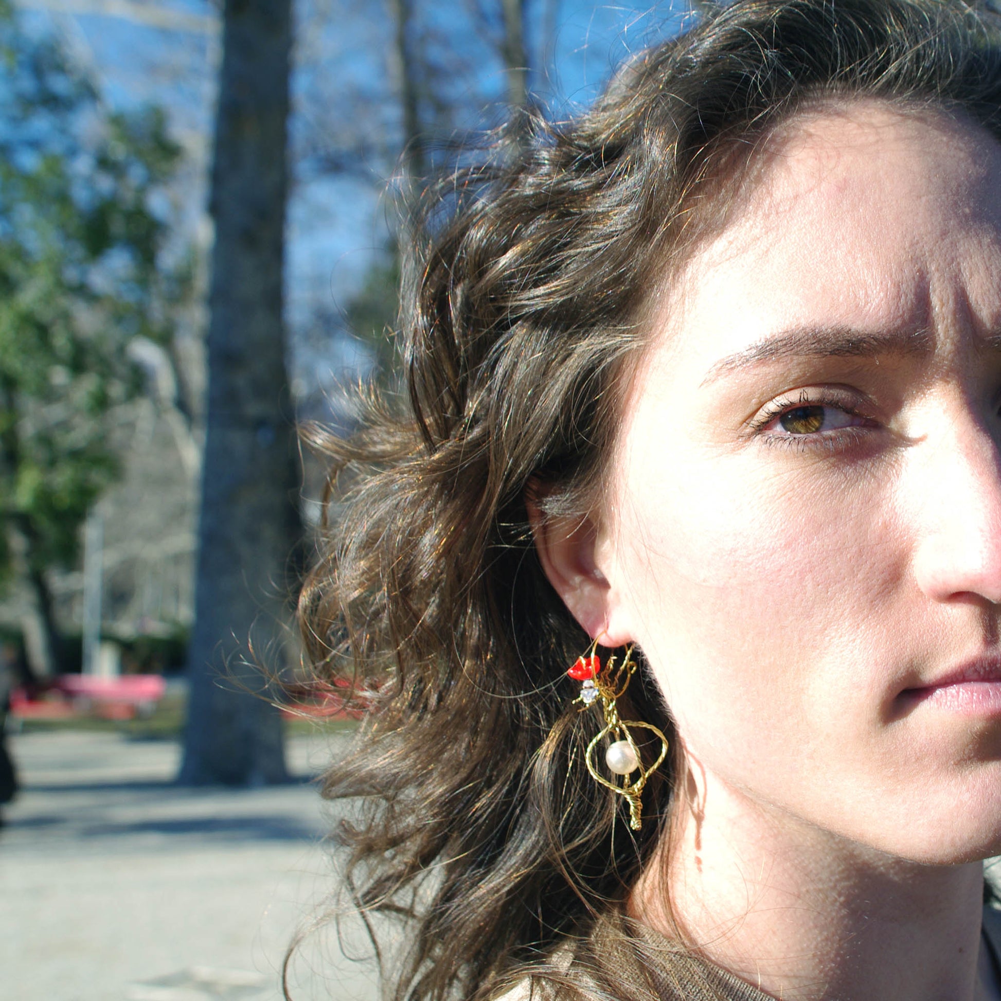 Valerie wearing the Ceres earrings , twisted wire, opals, pearl and red flower detail. 