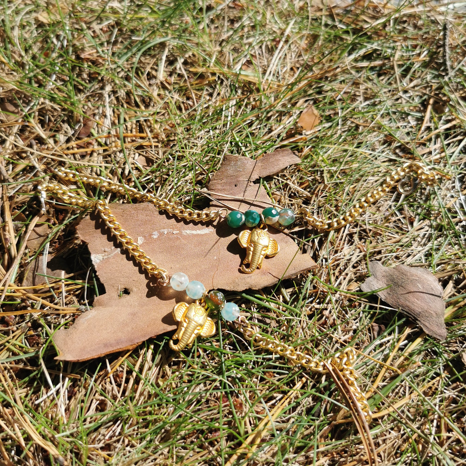 Elephants charm bracelets turquoise beads in grass