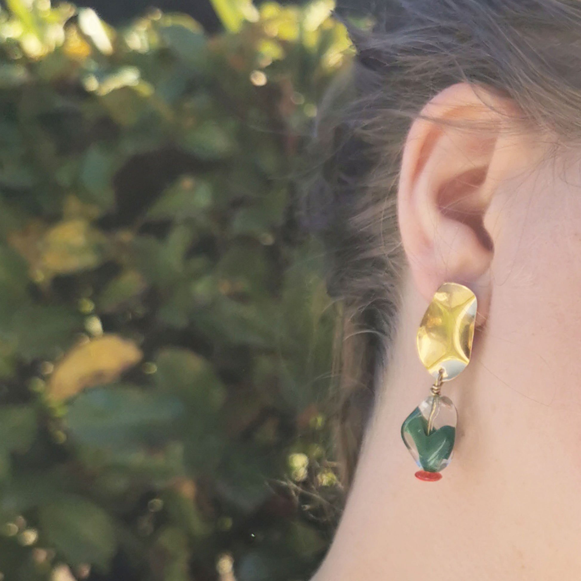 Holly style  figurative glass earrings worn on