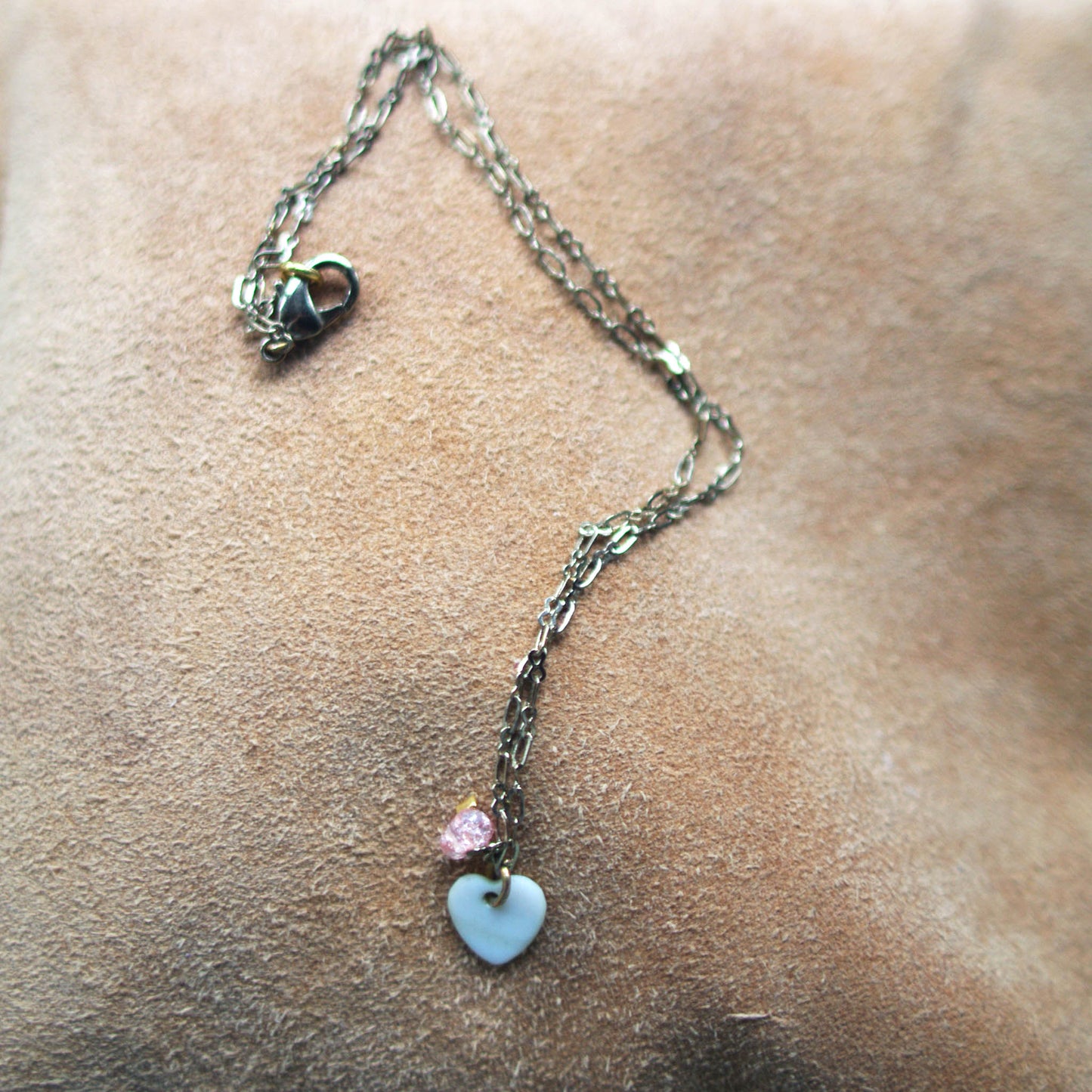 Heart of quartz necklace suede background